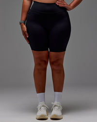 Woman wearing Fusion Ultra High-Rise 9" Short Pockets - Black | Model:Aimee | Size:XL