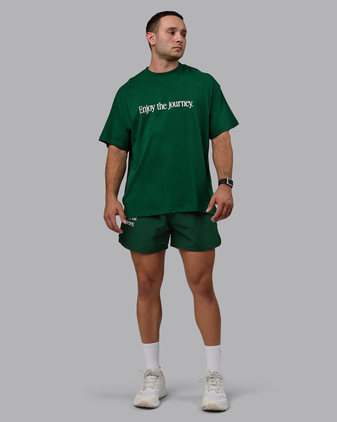 Man wearing Unisex Enjoy The Journey Heavyweight Tee Oversize - Deep Emerald-Off-White