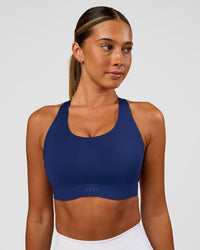 Woman wearing Stability High Support Sports Bra - Midnight Blue | Model:Charli | Size:XS (A-C Cup)