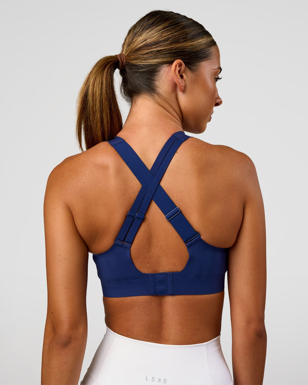 Woman wearing Stability High Support Sports Bra - Midnight Blue | Model:Charli | Size:XS (A-C Cup)