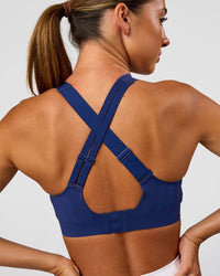 Woman wearing Stability High Support Sports Bra - Midnight Blue | Model:Charli | Size:XS (A-C Cup)