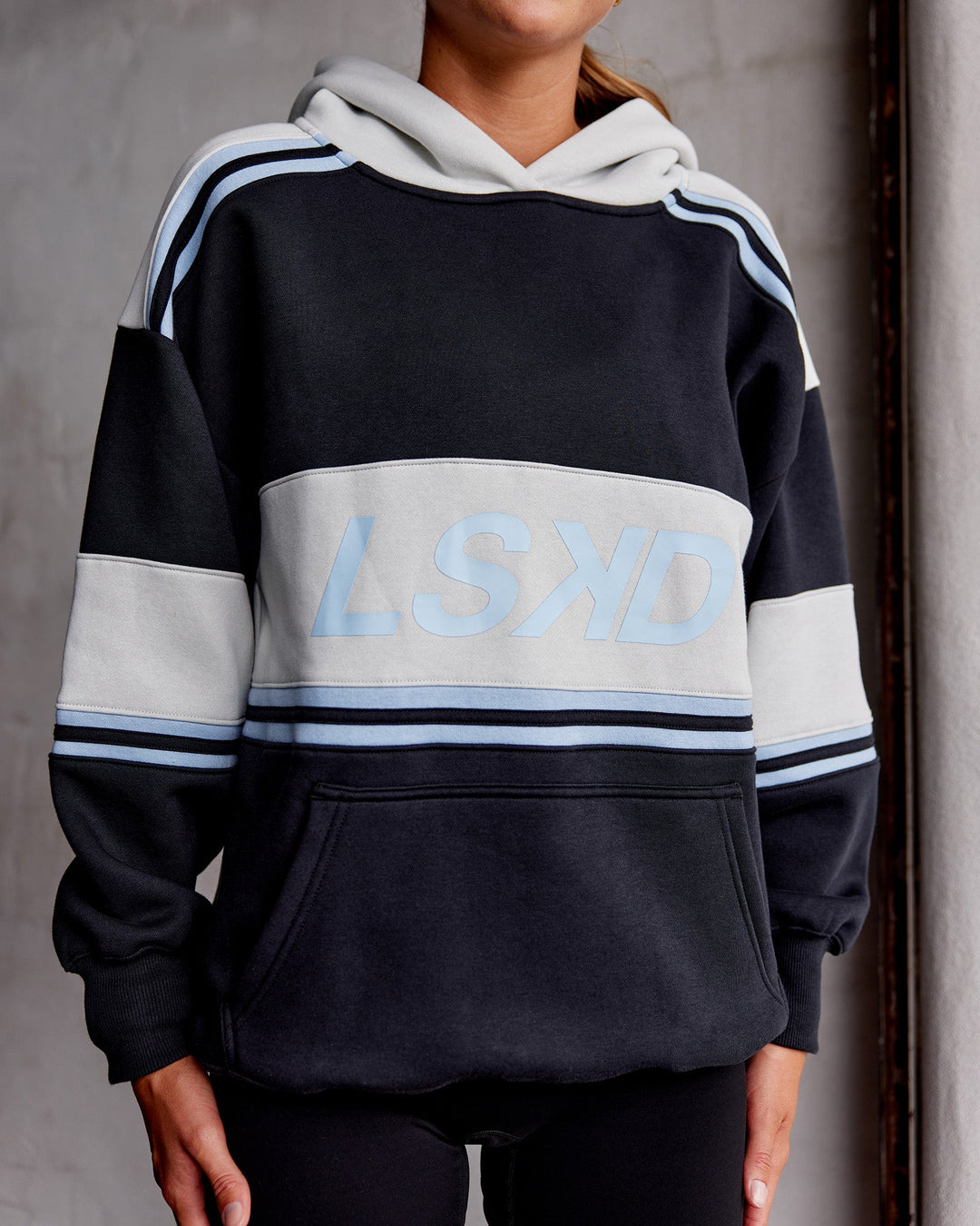 Woman wearing A-Team Oversized Hoodie - Caviar-Open Air | Model:Asia | Size:XS