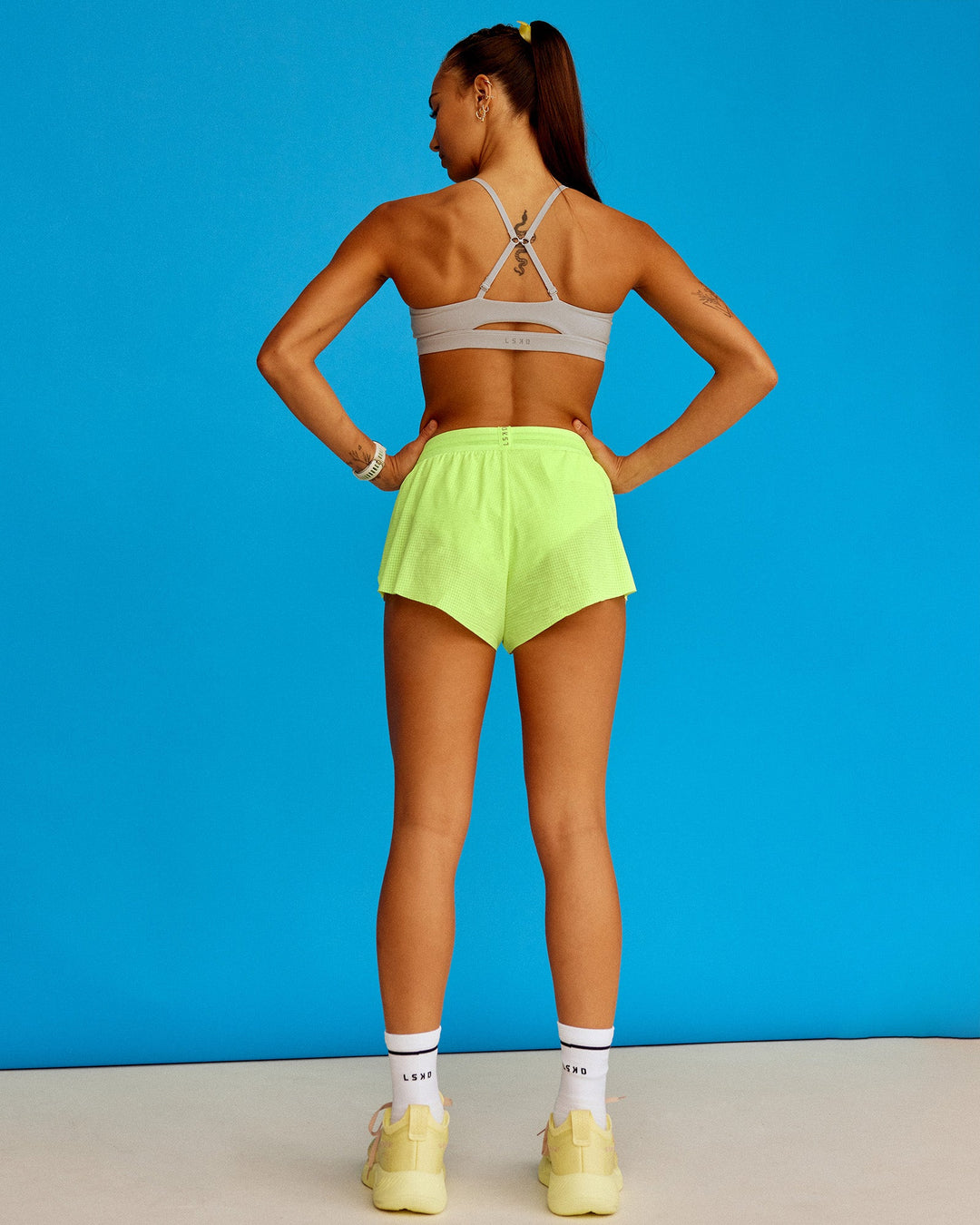 Woman wearing Accelerate 3&quot; Running Short - Lime Glo-Shale Beige | Model:Steph | Size:XS