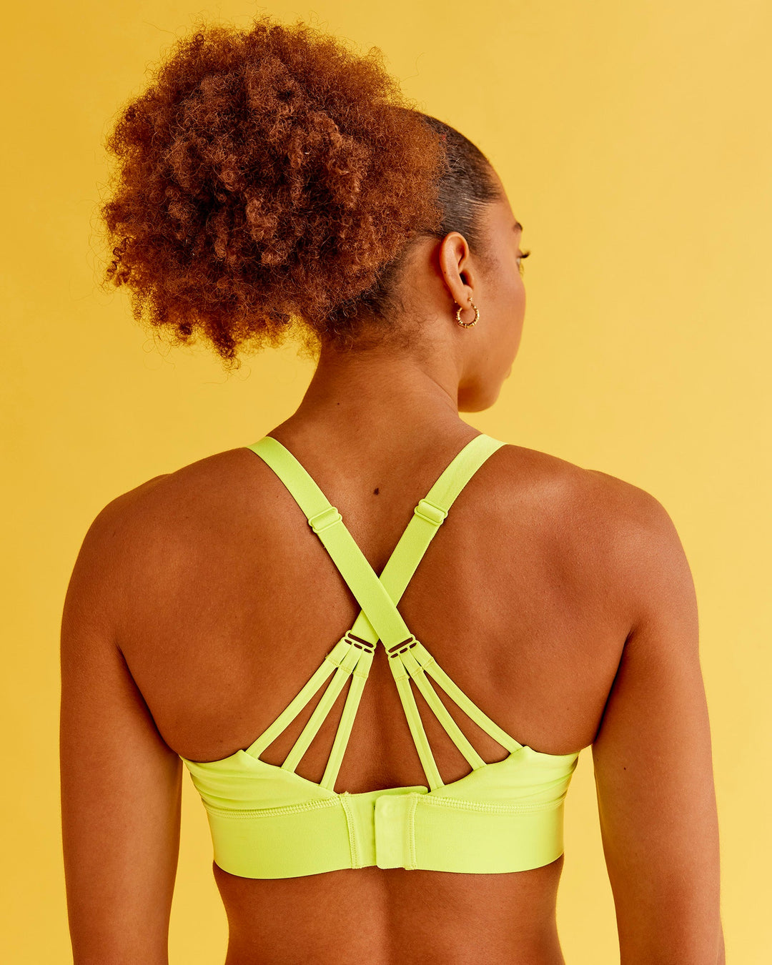 Woman wearing Accelerate Split Strap Sports Bra - Hyper Green | Model:Txai | Size:XS