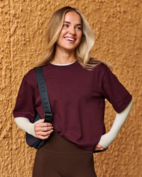 Woman wearing AfterDark ZeroCrease Cropped Tee - Cherry Lacquer | Model:Issy | Size:XS