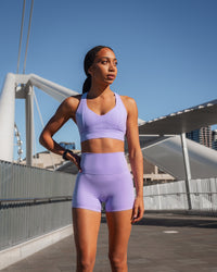 Woman wearing Elixir Ultra High-Rise 4" Short - Violet Ray | Model:Txai | Size:XS