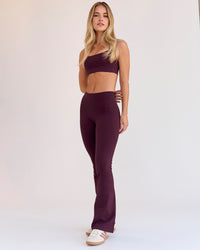 Woman wearing Fusion V-Contour High-Rise Flared Petite Legging Pockets - Cherry Lacquer | Model:Issy | Size:XS | Thumbnail Index: 9