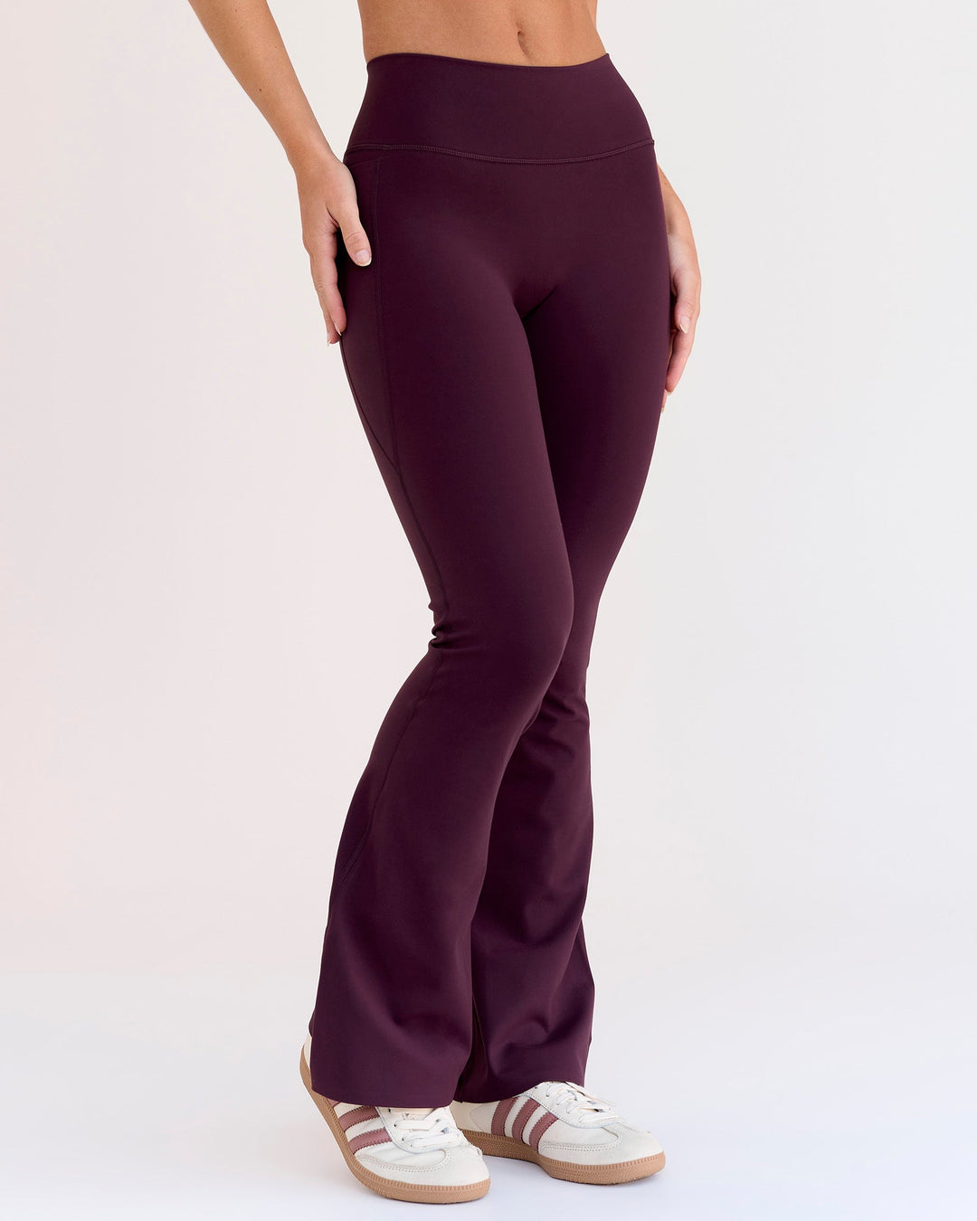 Woman wearing Fusion V-Contour High-Rise Flared Petite Legging Pockets - Cherry Lacquer | Model:Issy | Size:XS - view 9