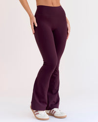 Woman wearing Fusion V-Contour High-Rise Flared Petite Legging Pockets - Cherry Lacquer | Model:Issy | Size:XS | Thumbnail Index: 8