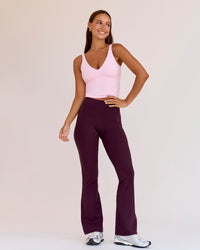 Woman wearing Fusion V-Contour High-Rise Flared Petite Legging Pockets - Cherry Lacquer | Model:Brylee | Size:XS | Thumbnail Index: 0