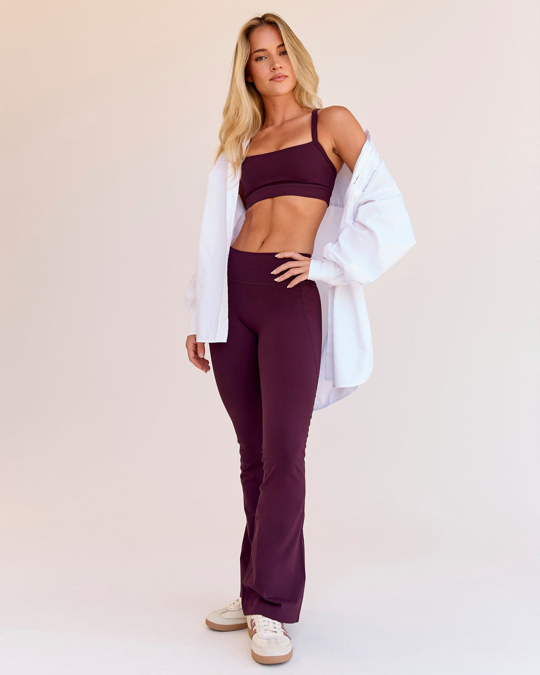 Woman wearing Fusion V-Contour High-Rise Flared Petite Legging Pockets - Cherry Lacquer | Model:Issy | Size:XS - view 2