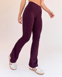 Woman wearing Fusion V-Contour High-Rise Flared Petite Legging Pockets - Cherry Lacquer | Model:Issy | Size:XS | Thumbnail Index: 6