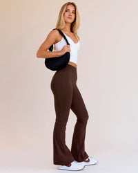 Woman wearing Fusion V-Contour High-Rise Flared Petite Legging Pockets - Hot Chocolate | Model:Issy | Size:XS