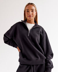 Woman wearing Go-To Oversized Quarter Zip Sweater - Black | Model:Jaimee | Size:XS | Thumbnail Index: 0