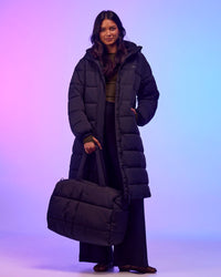 Woman wearing Go-To Puffer Long Jacket - Black | Model:Alex | Size:XS