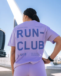 Woman wearing Love The Run FLXCotton Tee Oversize - Violet Ray-Royal Purple | Model:Txai | Size:XS