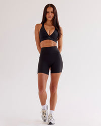 Woman wearing O.G Fusion Ultra High-Rise 6" Short Pockets - Black | Model:Eliza | Size:XS