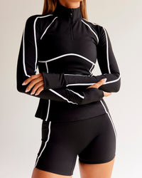 Woman wearing Power Quarter Zip Jacket - Black | Model:Charli | Size:XS