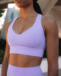 Woman wearing Sculpt Sports Bra - Violet Ray | Model:Txai | Size:XS