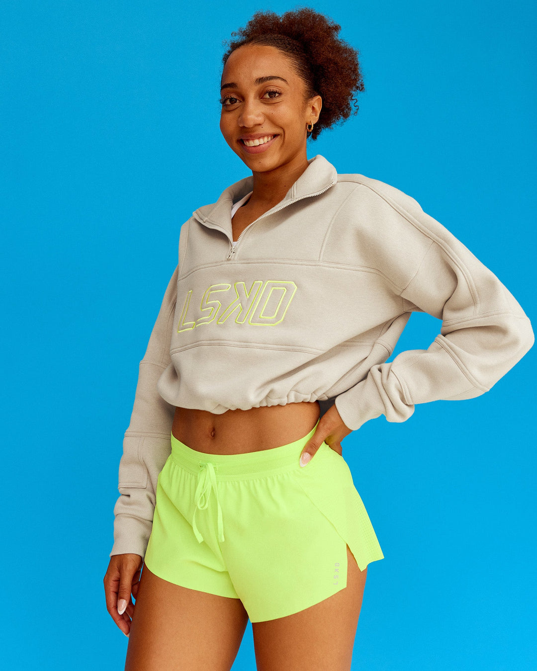 Woman wearing Slam Quarter Zip Sweater - Shale Beige-Lime Glo | Model:Txai | Size:XS