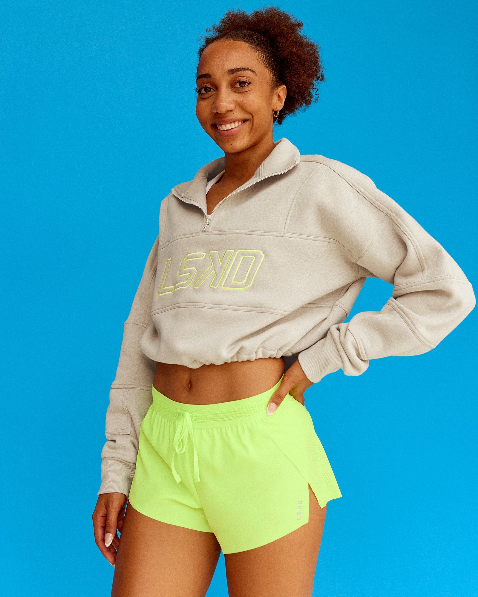 Woman wearing Slam Quarter Zip Sweater - Shale Beige-Lime Glo | Model:Txai | Size:XS