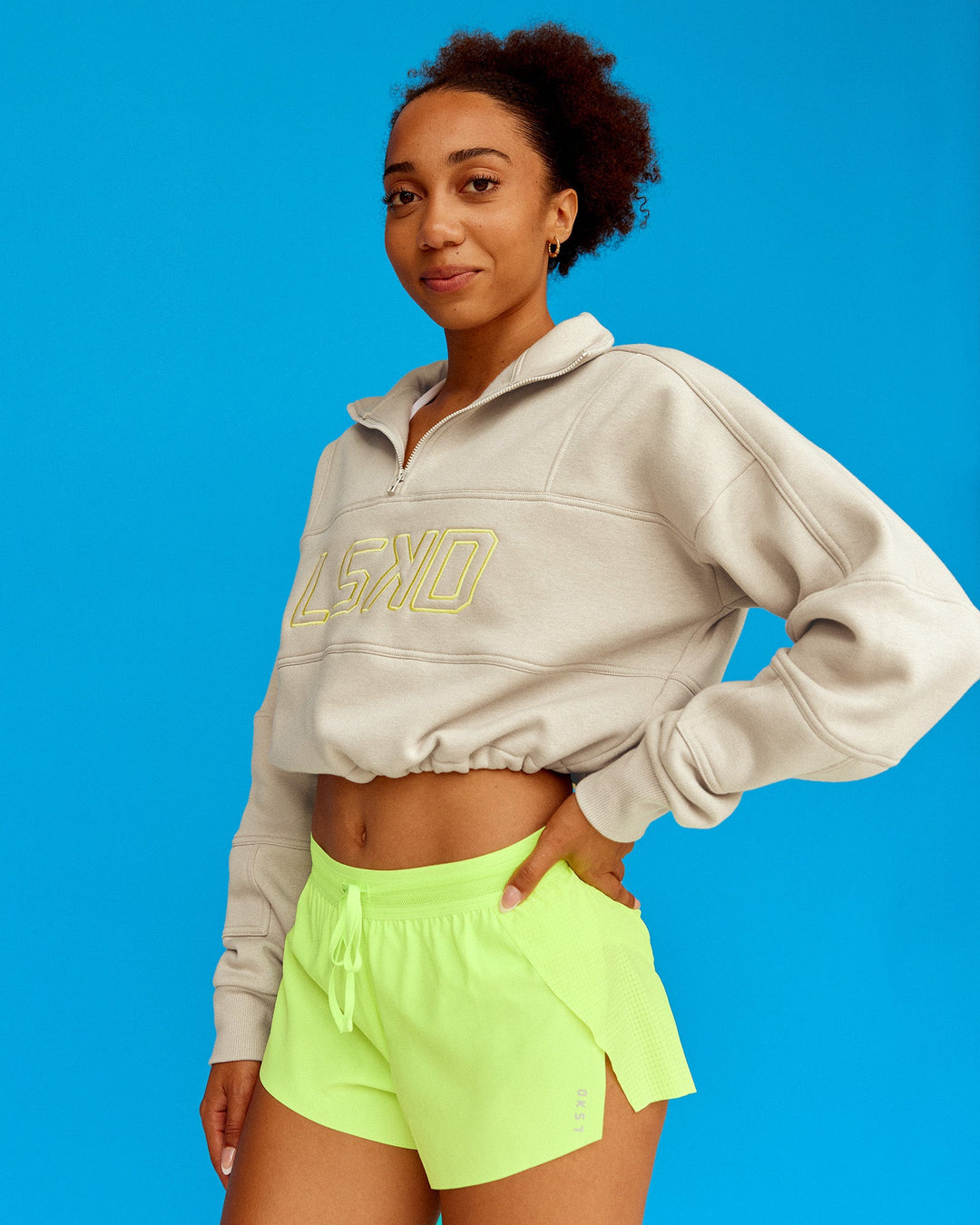 Woman wearing Slam Quarter Zip Sweater - Shale Beige-Lime Glo | Model:Txai | Size:XS