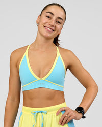 Woman wearing Breeze Sports Bra - Baltic Sea-Lemon | Model:Grace | Size:XS