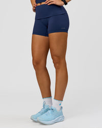 Woman wearing Groovy High Rise Fold Over 4" Short - Future Navy | Model:Grace | Size:XS