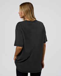 Woman wearing 1% Better Every Day EST FLXCotton Oversized Tee - Black Washed | Model:Leilani | Size:XS