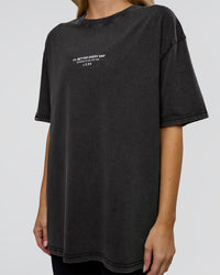 Woman wearing 1% Better Every Day EST FLXCotton Oversized Tee - Black Washed | Model:Leilani | Size:XS
