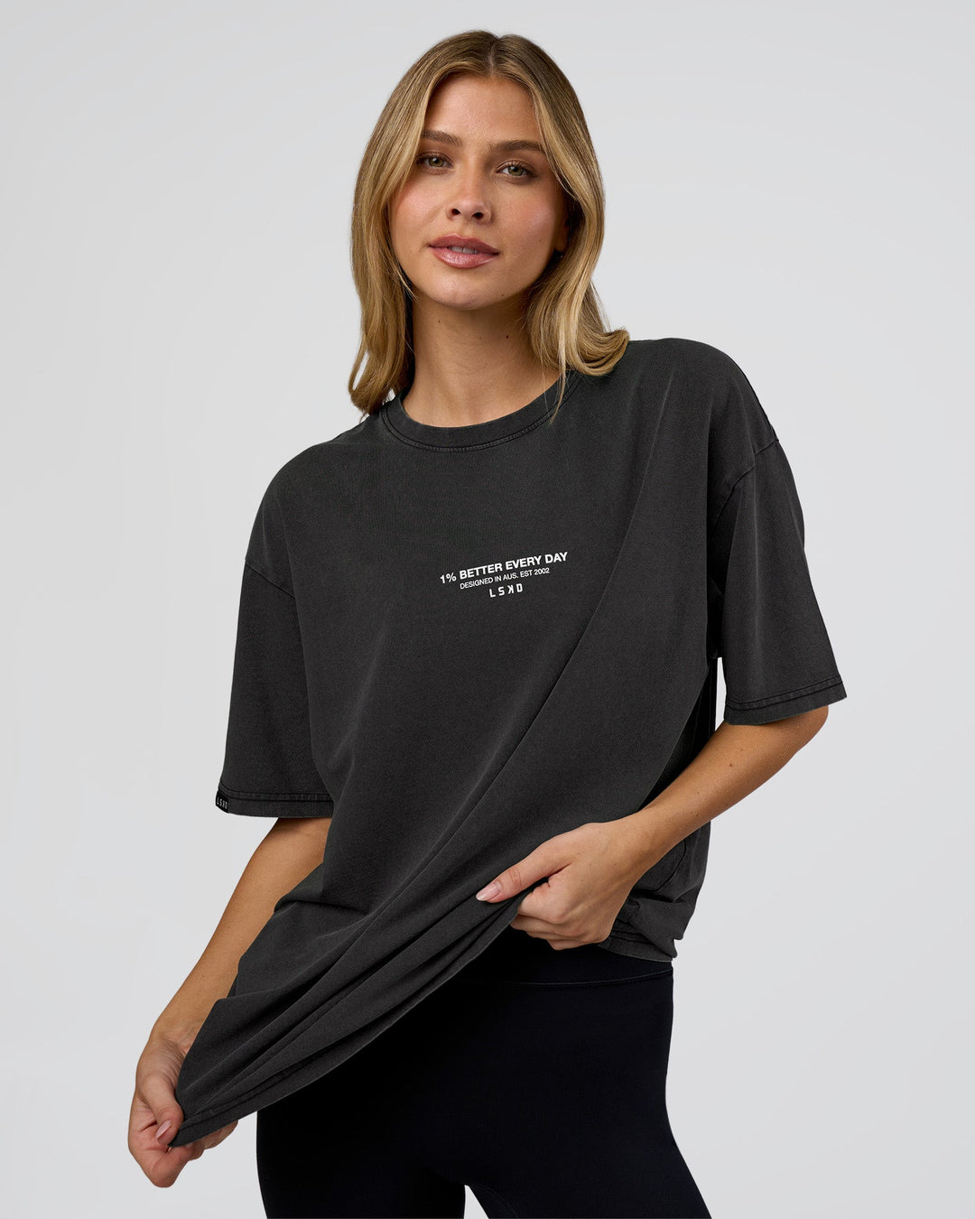 Woman wearing 1% Better Every Day EST FLXCotton Oversized Tee - Black Washed | Model:Leilani | Size:XS