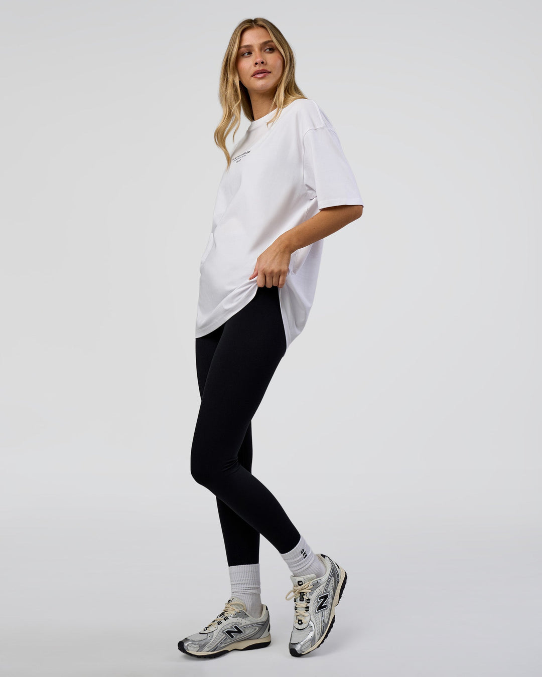 Woman wearing 1% Better Every Day EST FLXCotton Oversized Tee - White | Model:Leilani | Size:XS