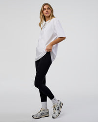 Woman wearing 1% Better Every Day EST FLXCotton Oversized Tee - White | Model:Leilani | Size:XS