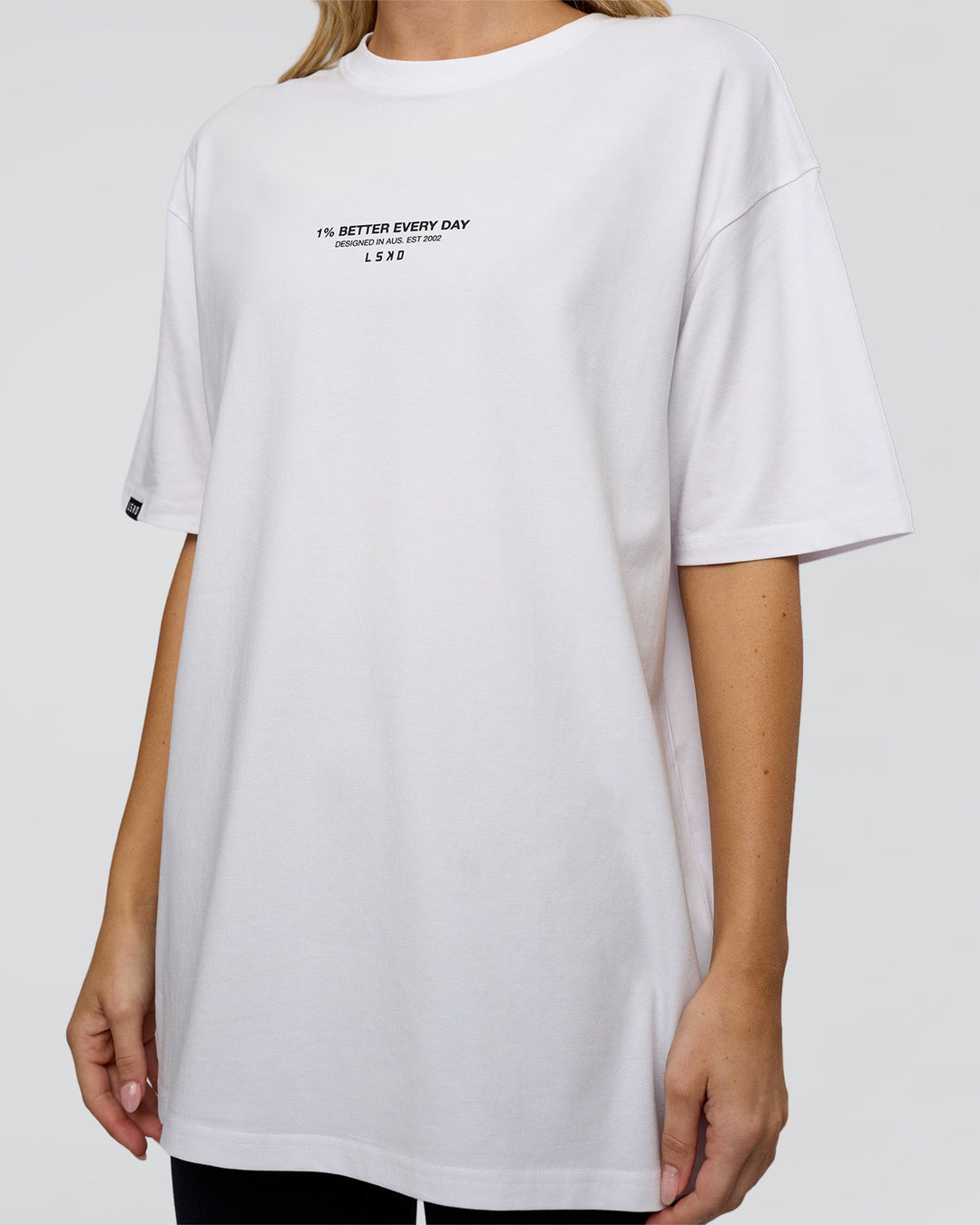 Woman wearing 1% Better Every Day EST FLXCotton Oversized Tee - White | Model:Leilani | Size:XS