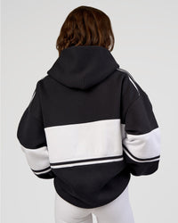 Woman wearing A-Team Oversized Hoodie - Caviar-White | Model:Dakota | Size:XS