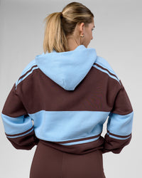 Woman wearing A-Team Oversized Hoodie - Hot Chocolate-Open Air | Model:Amity | Size:XS