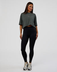Woman wearing Abstract Haze FLXCotton Tee - Carbon Green-Cantaloupe | Model:Bianca | Size:XS