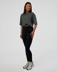 Woman wearing Abstract Haze FLXCotton Tee - Carbon Green-Cantaloupe | Model:Bianca | Size:XS