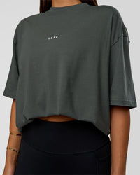 Woman wearing Abstract Haze FLXCotton Tee - Carbon Green-Cantaloupe | Model:Bianca | Size:XS