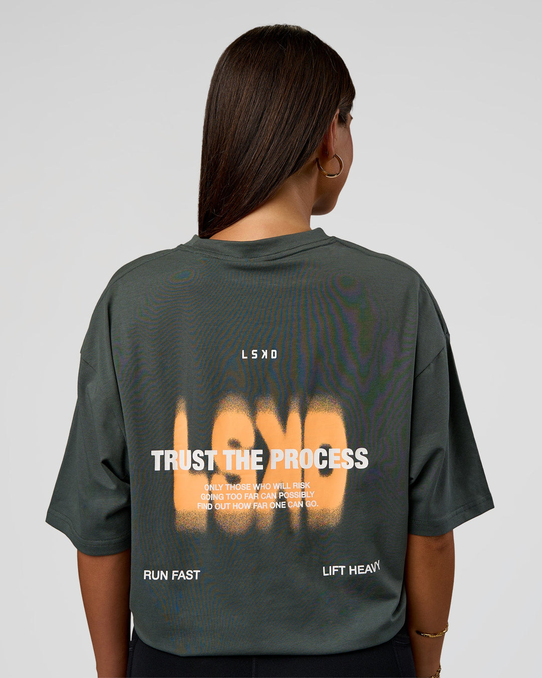 Woman wearing Abstract Haze FLXCotton Tee - Carbon Green-Cantaloupe | Model:Bianca | Size:XS