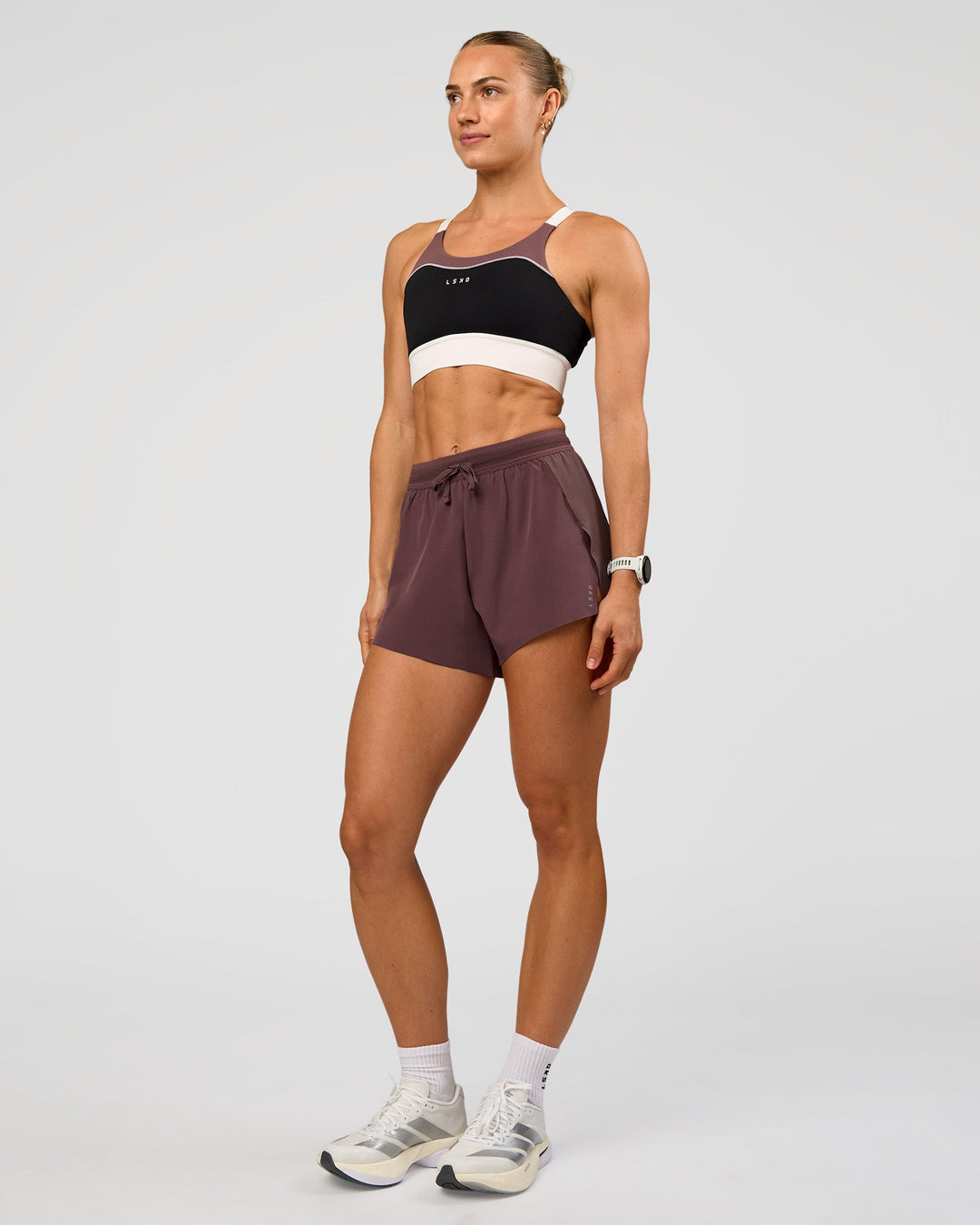 Woman wearing Accelerate 3" High-Rise Running Short - Cocoa Powder | Model:Maja | Size:XS