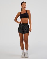 Woman wearing Accelerate 3" High-Rise Running Short - Energy Print Black | Model:Brylee | Size:XS