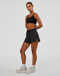 Woman wearing Accelerate 3" High-Rise Running Short - Energy Print Black | Model:Brylee | Size:XS