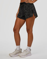 Woman wearing Accelerate 3" High-Rise Running Short - Energy Print Black | Set:true | Angle:side | Model:Brylee | Size:XS | Thumbnail Index: 1