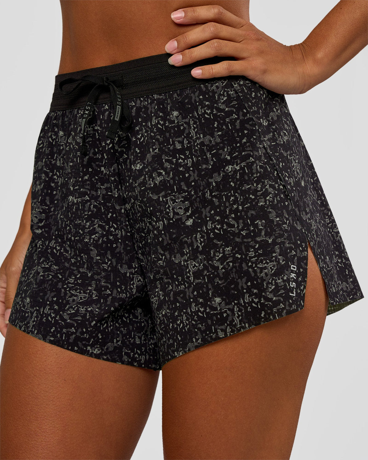 Woman wearing Accelerate 3" High-Rise Running Short - Energy Print Black | Set:true | Angle:closeup | Model:Brylee | Size:XS - view 1