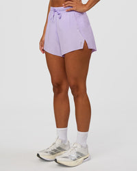 Woman wearing Accelerate 3" High-Rise Running Short - Pale Lilac | Set:true | Angle:side | Model:Brylee | Size:XS