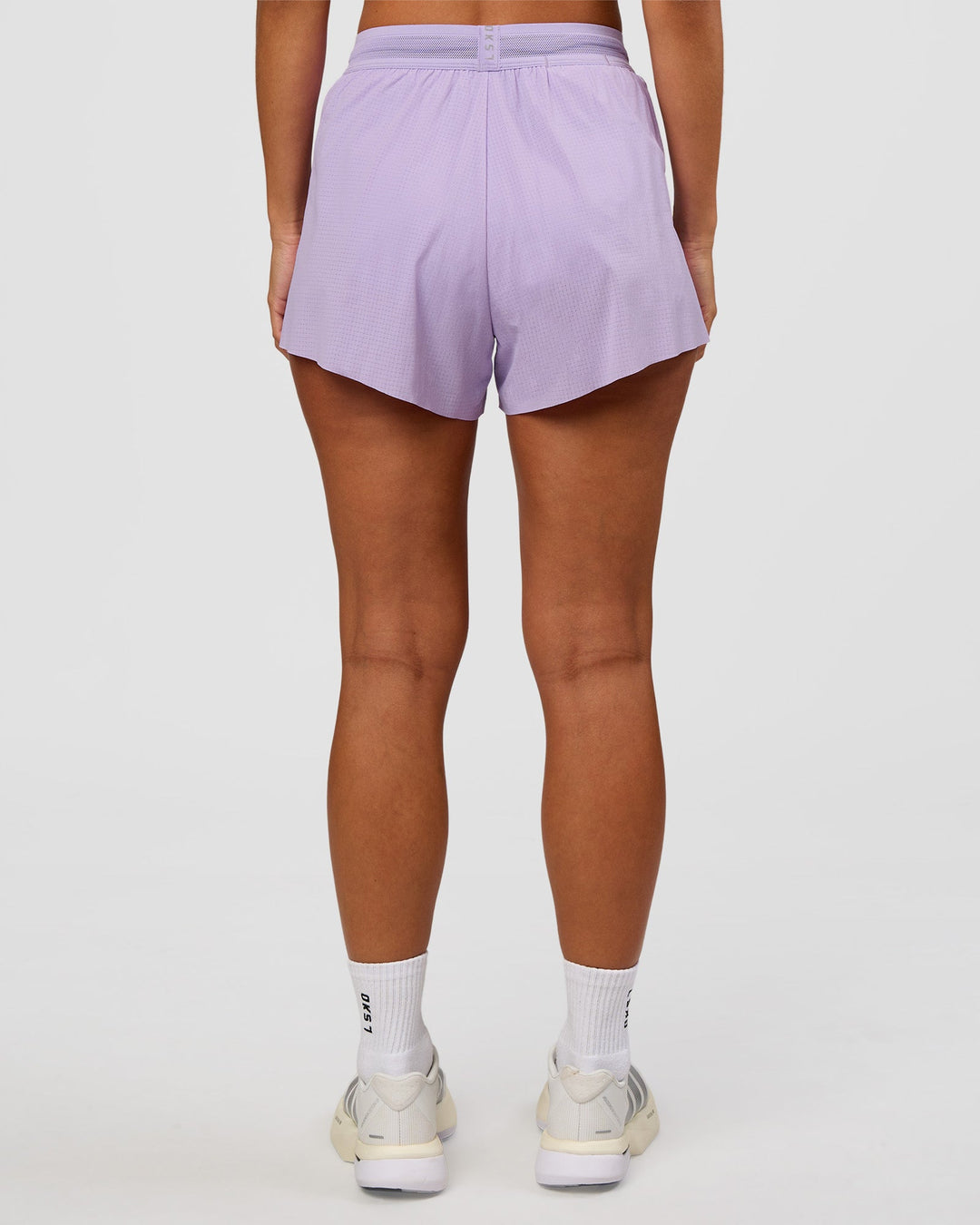Woman wearing Accelerate 3" High-Rise Running Short - Pale Lilac | Set:true | Angle:back | Model:Brylee | Size:XS