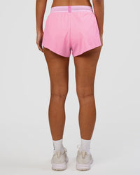 Woman wearing Accelerate 3" Mid-Rise Running Short - Candy Pink-Marshmallow | Set:true | Angle:back | Model:Brylee | Size:XS