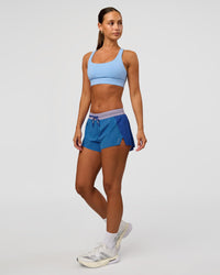 Woman wearing Accelerate 3" Mid-Rise Running Short - Electric Indigo-Multi | Model:Brylee | Size:XS