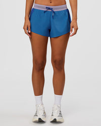 Woman wearing Accelerate 3" Mid-Rise Running Short - Electric Indigo-Multi | Set:true | Angle:front | Model:Brylee | Size:XS